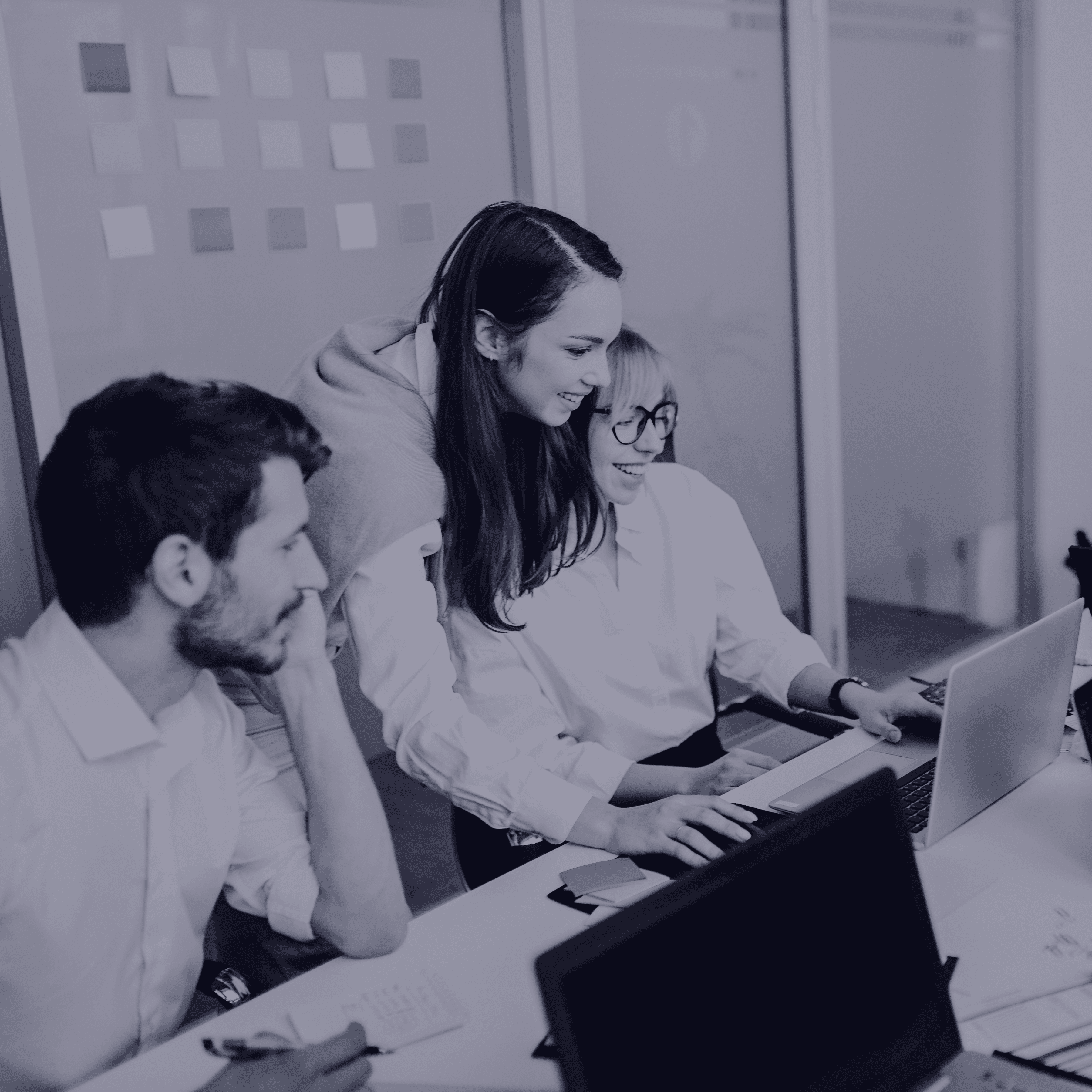 Colleagues collaborating on a laptop